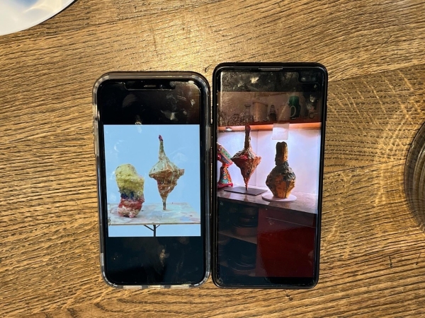 Detail from Franz West's Telefonat (1997)
                                          on a phone, and a photo on the phone of Sophia Stolz's recreation of West's work in cake for the Slime exhibition at Secession,
                                          February 2024.